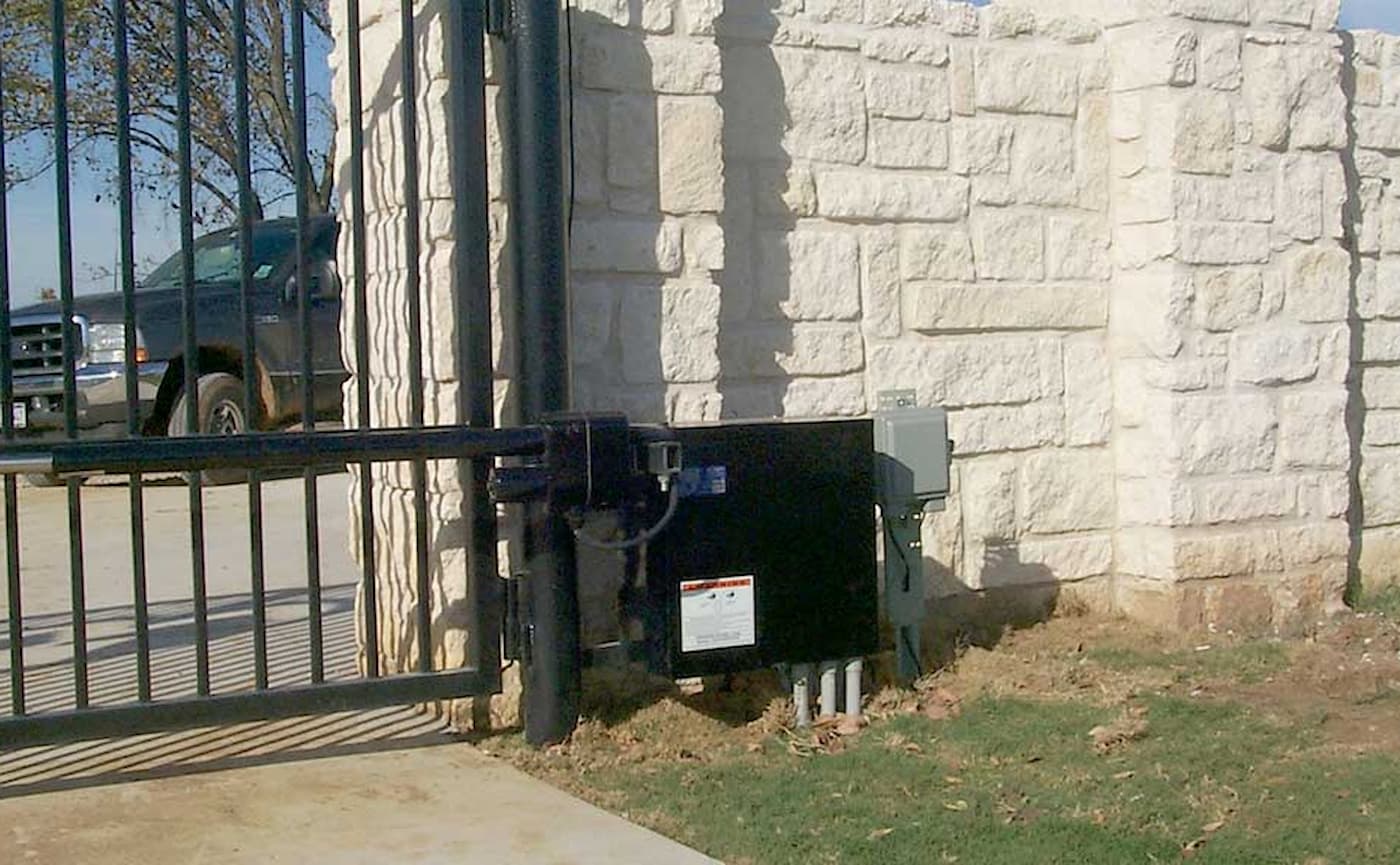 Patriot gate opener installed on an iron gate