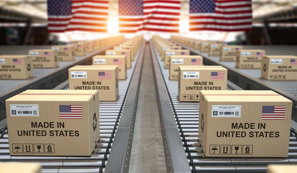 Cardboard boxes with text made in USA and american flag on the roller conveyor